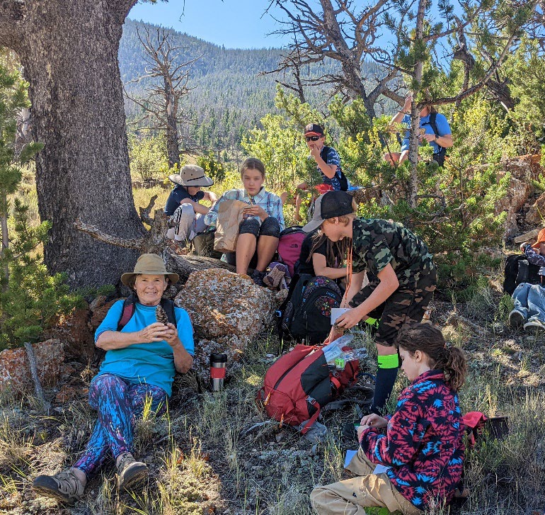 A photograph of Meredith Taylor and Camp Bighorn students gathered in Torrey Valley